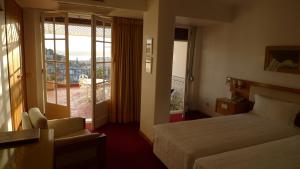 Ένα ή περισσότερα κρεβάτια σε δωμάτιο στο Albergaria Senhora do Monte +21 φωτογραφίες