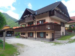 a large house with balconies on the side of it at Apartma Slavc in Kranjska Gora