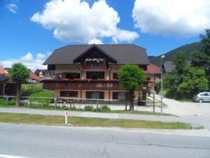 a large house on the side of a street at Apartma Slavc in Kranjska Gora