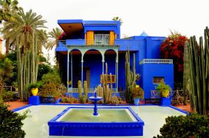 a blue house with a fountain in front of it at El Hamra Hotel in Marrakech