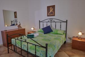 a bedroom with a bed and a dresser and a mirror at Casa Maja in Badolato