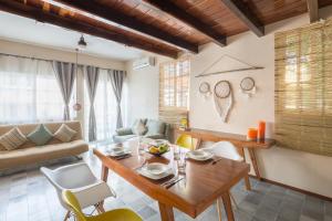 a living room with a wooden table and chairs at Quinta Margarita - Boho Chic Hotel in Playa del Carmen