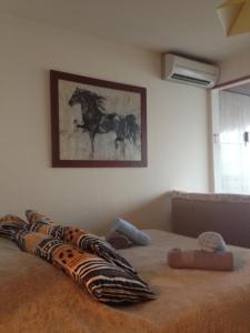 a bed with a picture of a horse on the wall at Sea View Astrella in Nice