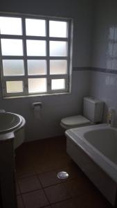 a bathroom with a tub and a toilet and a window at CASA Beirada Monte y Playa in Carnota +43 photos