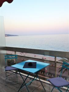 a table and chairs on a balcony overlooking the beach at Sea View Astrella in Nice