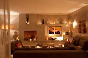 a living room with a couch and a fireplace at Riad Dar Maya in Essaouira
