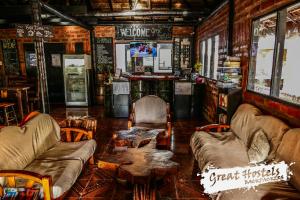 a room with chairs and tables in a bar at Great Hostels Backpackers in Baños +66 photos