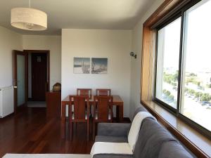 a living room with a couch and a table at Love Sea Apartment in Leça da Palmeira