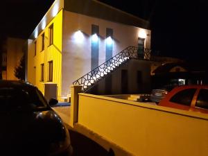 a building with a staircase on the side of it at night at N.D Global Alba Iulia in Alba Iulia