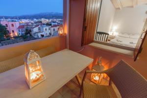 a dining room with a table and chairs and a window at KasteliSuites in Chania