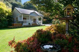 a small house with a porch and a yard at The Retreat Luxury Garden Villa in Taupo