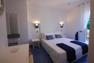 a bedroom with a large bed and a window at UNAHOTELS Club Hotel Ancora in Stintino