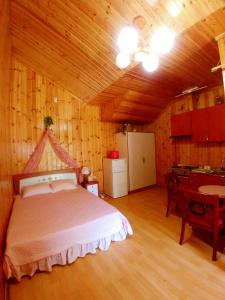 a bedroom with a bed in a wooden room at Nadeuri Pension in Pyeongchang