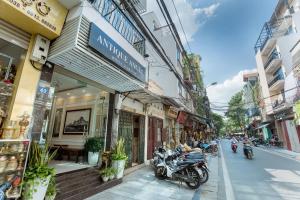 a street with motorcycles parked in front of buildings at Antique Angel Hotel in Hanoi