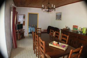 a kitchen and dining room with a table and chairs at les écureuils in Saint-Priest