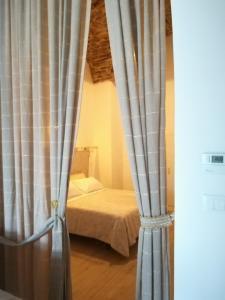 a room with a bed and a window with curtains at Belvedere dei monti Dauni di Castelluccio valmaggiore in Castelluccio Valmaggiore