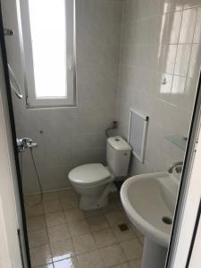 a white bathroom with a toilet and a sink at Guesthouse in Chernomorets next to Gradina and Sozopol in Chernomorets +27 photos