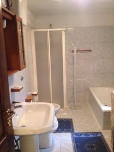 a bathroom with a shower and a toilet and a sink at Casa Olbia 2 in Olbia