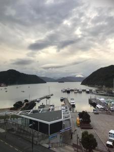 a marina with boats parked in the water at Astonishing Views Superb Waterfront Apartment in Picton