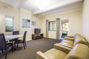 a living room with a couch and a table at Greenways Apartments in Adelaide