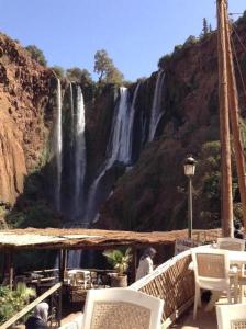 a view of a waterfall from the deck of a restaurant at DAR OUZOUD Vegan in Ouzoud