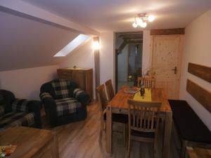 a living room with a table and chairs and a couch at Ferienhof Hering, Inhaber Ina Tharang in Hinterhermsdorf
