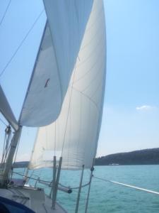 two white sails on a boat in the water at FeWo Segelwind in Bodman-Ludwigshafen
