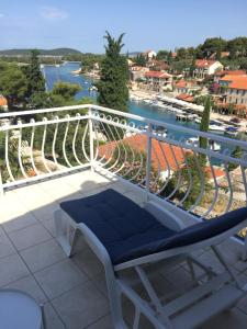 a balcony with a bench and a view of the water at Apartment in Maslinica 70m from the sea in Maslinica