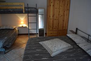 a bedroom with two bunk beds and a lamp at Le Quare in Gravellona Toce