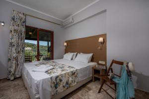 a hotel room with a bed and a window at Maria Studios in Keri