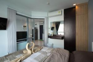 a bedroom with a bed with a towel on it at Grandblue Condo by malai in Mae Pim