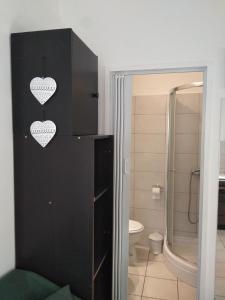 a bathroom with a black cabinet with hearts on it at Neva in Bilice