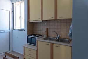 a kitchen with a sink and a stove at Unico in Lefkada