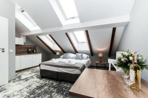 a bedroom with a bed and a table at Apartamenty L5 in Kraków