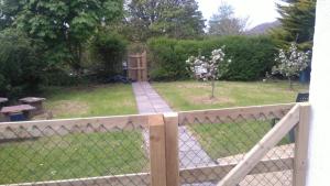 a fence with a garden in the background at Murrevagh Mealog in Tooreen +1 photo