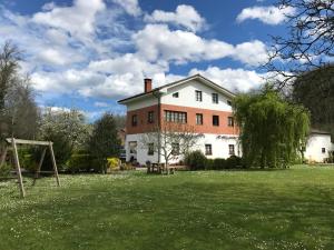 a large white house with a playground in the yard at Les Piperes in Corao