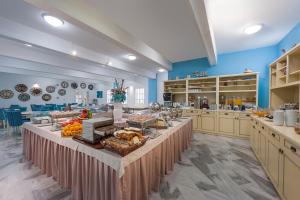 a large kitchen with a table with food on it at Narges Hotel in Aliki
