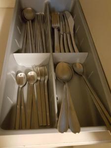 a drawer filled with lots of utensils and spoons at Haeundae Bada Condo in Busan
