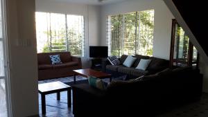a living room with a couch and a table at Dayspring Lodge in Nuku‘alofa