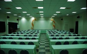 a large room with green tables and chairs at Fun Chen Resort Hotel in Liugui