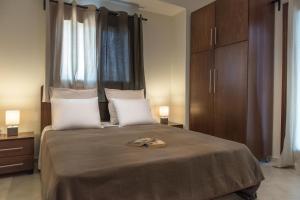 a bedroom with a large bed with two white pillows at Pleiades Casual Living in Nea Roda