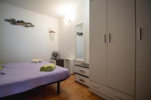 a bedroom with a bed and a large white cabinet at Casa Checa Apartment 1 in Cotillo