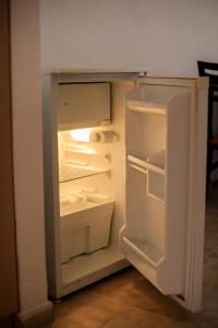 an empty refrigerator with its door open in a kitchen at Sunny Holiday Apartments in Sunny Beach