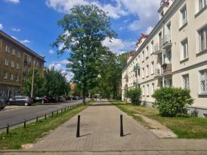 a street with trees and a street sign on it at Warszawa Stare Bielany in Warsaw