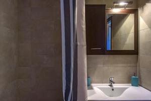 a bathroom with a sink and a mirror at Pleiades Casual Living in Nea Roda +43 photos