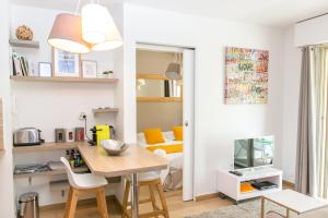 a kitchen and living room with a table and a bed at Cannes Le Vendome in Cannes