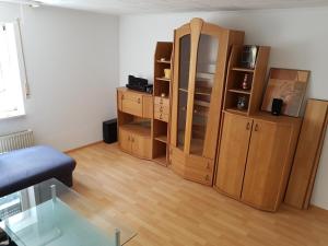 a living room with wooden furniture and a glass table at Ferienwohnung im Mühlbachtal in Miehlen