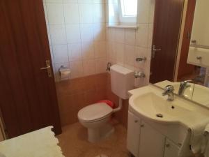 a bathroom with a toilet and a sink at Apartments Jelić in Banići