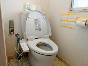 a bathroom with a toilet with the lid up at Duplex Makishi in Makishimachi +11 photos