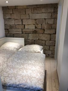a bedroom with a brick wall and a bed at Fritsch Häusel in Neustadt an der Weinstraße